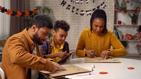 family crafting halloween decorations together
