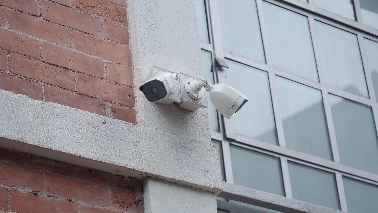 Two Security Cameras Mounted on a Building Wall