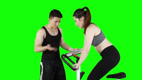 woman exercising on exercise bike with trainer