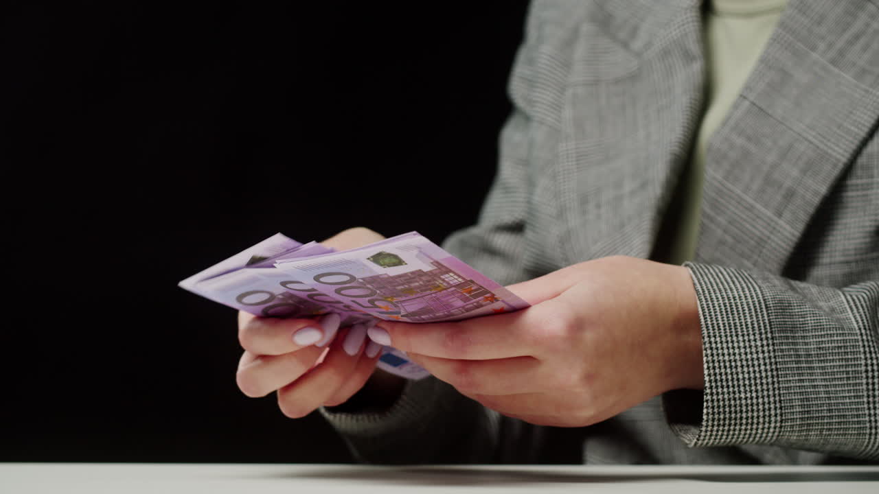 Close-up of hands holding euro banknotes