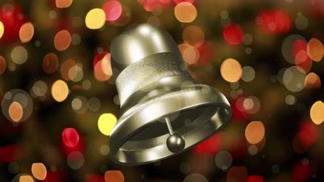 Animation-of-silver-christmas-bell-ringing-over-defocussed-flashing-fairy-lights