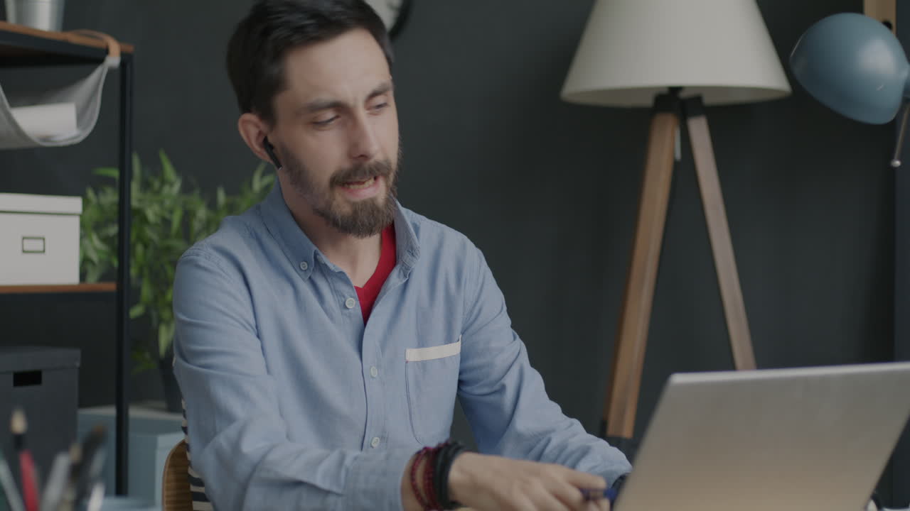 Man in video call on laptop in office