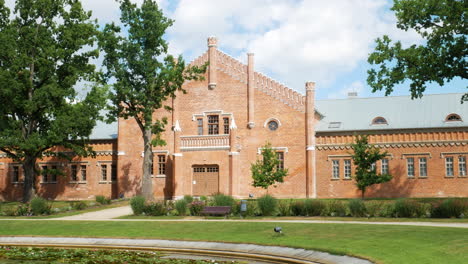 Redbrick-stable-of-Oginskis-manor-on-sunny-day,-static-view