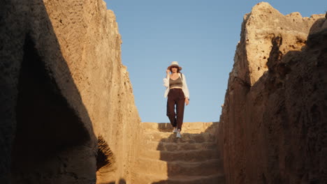 woman exploring ancient tomb ruins in cyprus