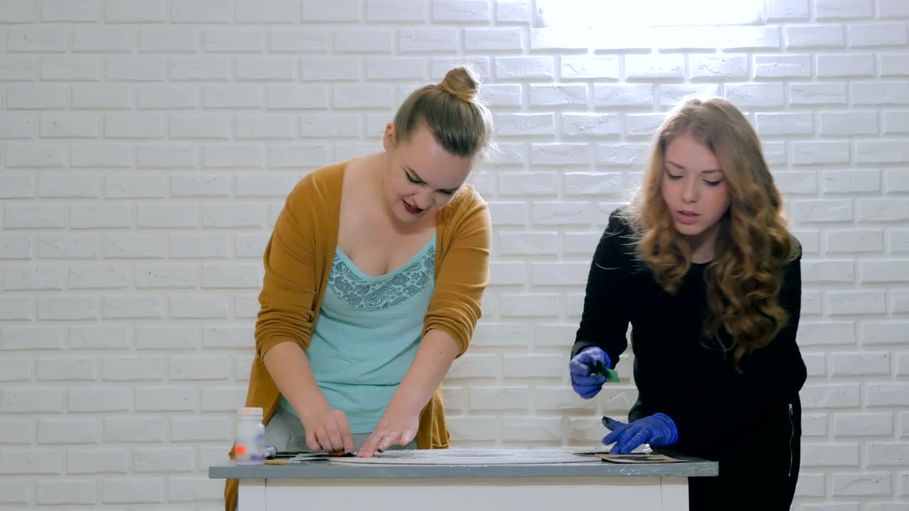 mujeres decoradoras, diseñadoras pintando decoración de círculos de madera