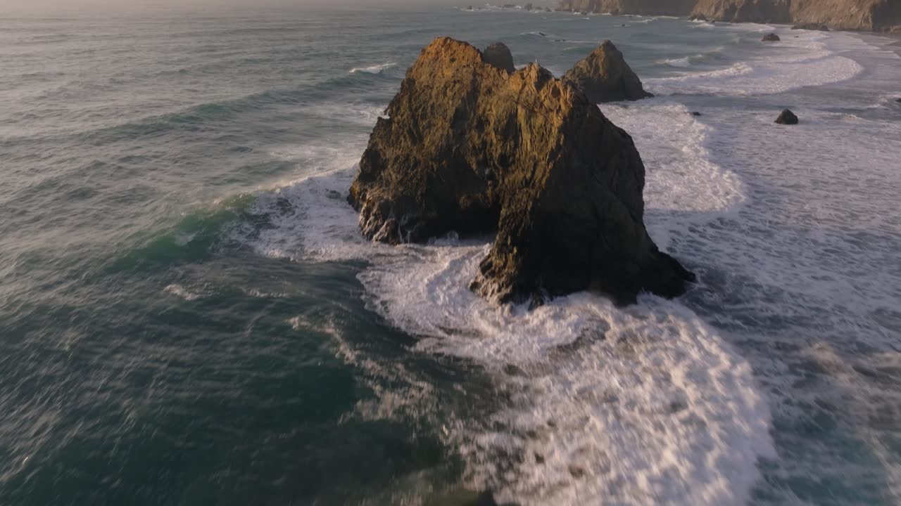 Waves crashing along California Coastline Sea Stacks, aerial view