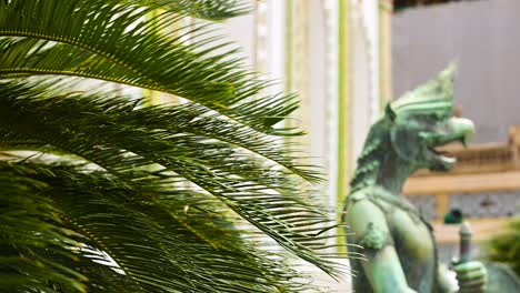 palm leaves and architecture of a thai temple