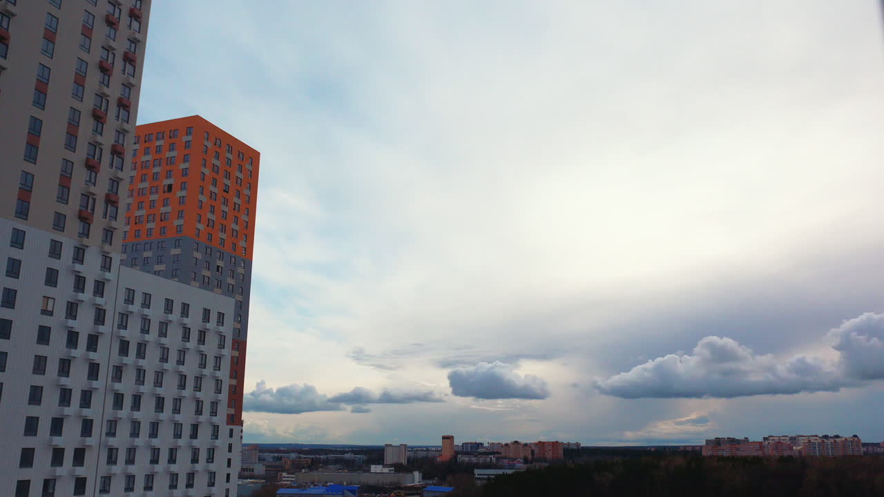 Cityscape View with Modern Apartment Buildings and Clouds