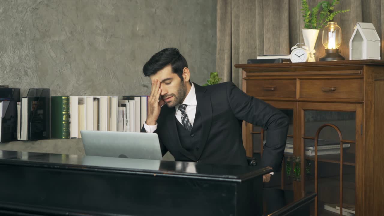 Sad business middle east man, CEO person working late from home at night, thinking about problem with computer notebook laptop and suffering from depression in quarantine. Negative.