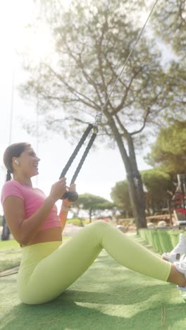 woman exercising outdoors with resistance bands at an outdoor gym