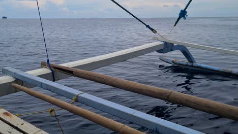 filipino bangka traditional boat sailing in sea water, point of view