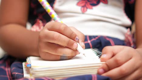 child writing in a notebook