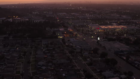 Culver-City-residential-neighborhood-area-in-part-of-Los-Angeles,-California-at-purple-dusk-after-sunset,-Scenic-Aerial-dolly-in-forward-wide-shot