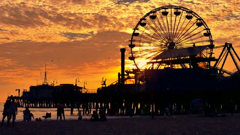 sunset at the beach pier with ferris wheel