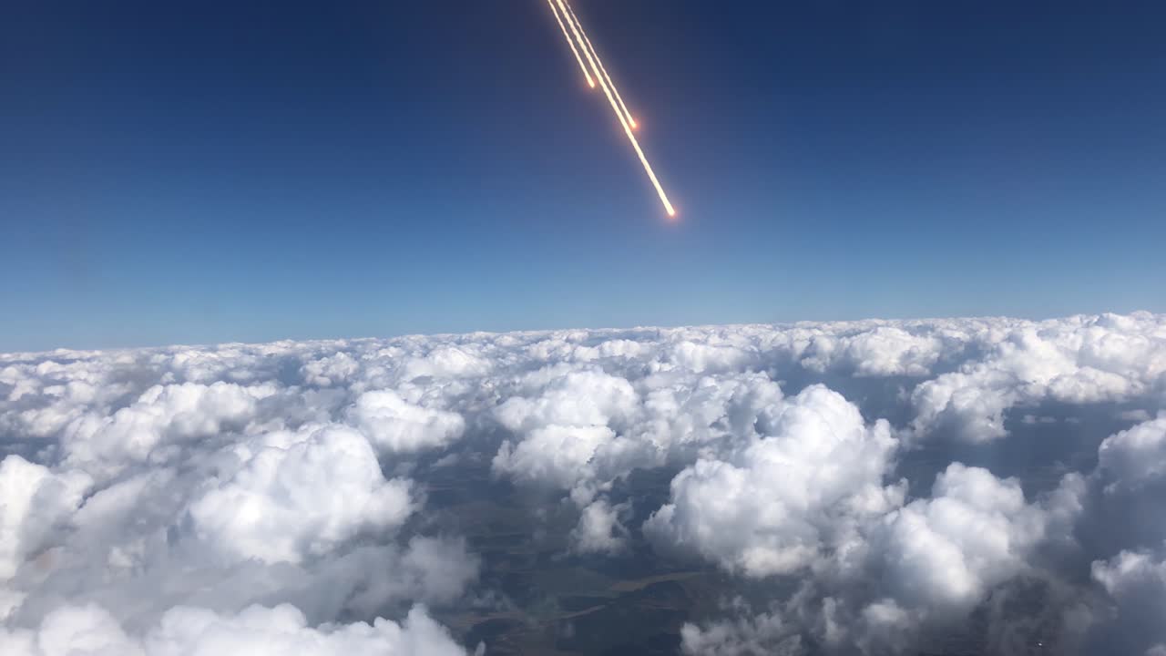 High-Altitude View of Rocket Launch over Clouds