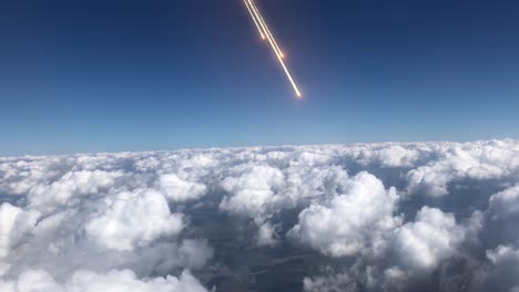 high-altitude view of rocket launch over clouds