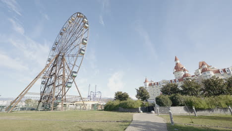 amusement park with ferris wheel and castle-like hotel