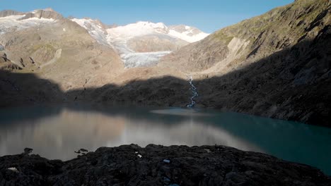 Aerial-view-of-Gauli-glacier-in-the-Bernese-Oberland-region-of-the-Swiss-Alps-with-a-view-of-the-glacial-lake-in-the-shadows-of-sunrise