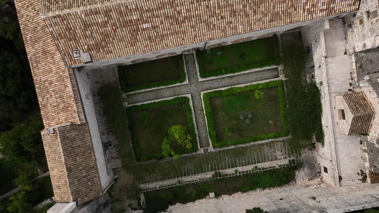 Spiral drone shot over Mljet Castle garden in the day in Croatia