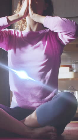 animation of light spots over caucasian woman practicing yoga and meditating