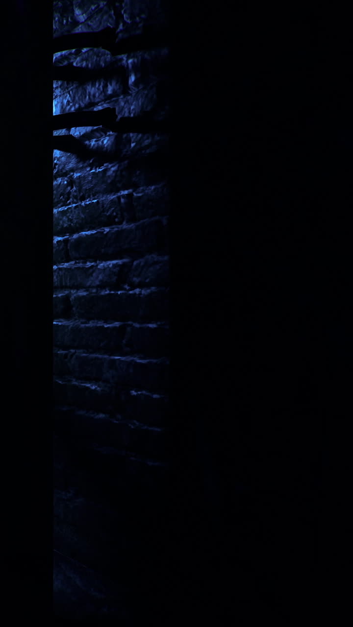 Light shining through a doorway in a dark hallway at night
