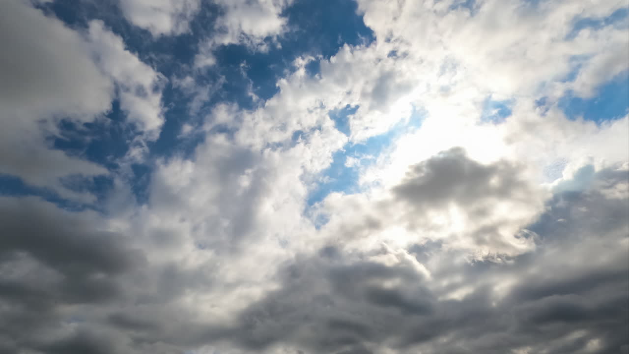 Heavy dark clouds gathering in the skies. Cloudscape quick formation timelapse. Low angle view.