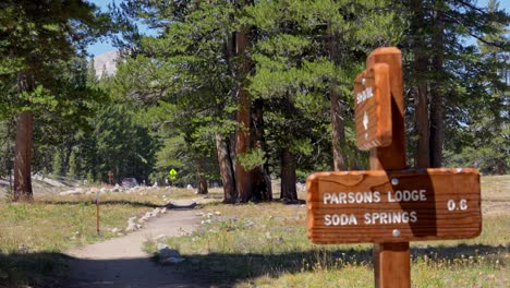4k close-up captures a weather-worn wooden trail signpost for soda springs in tuolumne meadows, yosemite national park. perfect b-roll for travel, hiking, nature, or outdoor-adventure projects