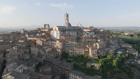 aerial view of siena, tuscany, italy at sunrise with duomo di siena and medieval town in 4k, descending