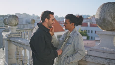 two men enjoying time together on a balcony