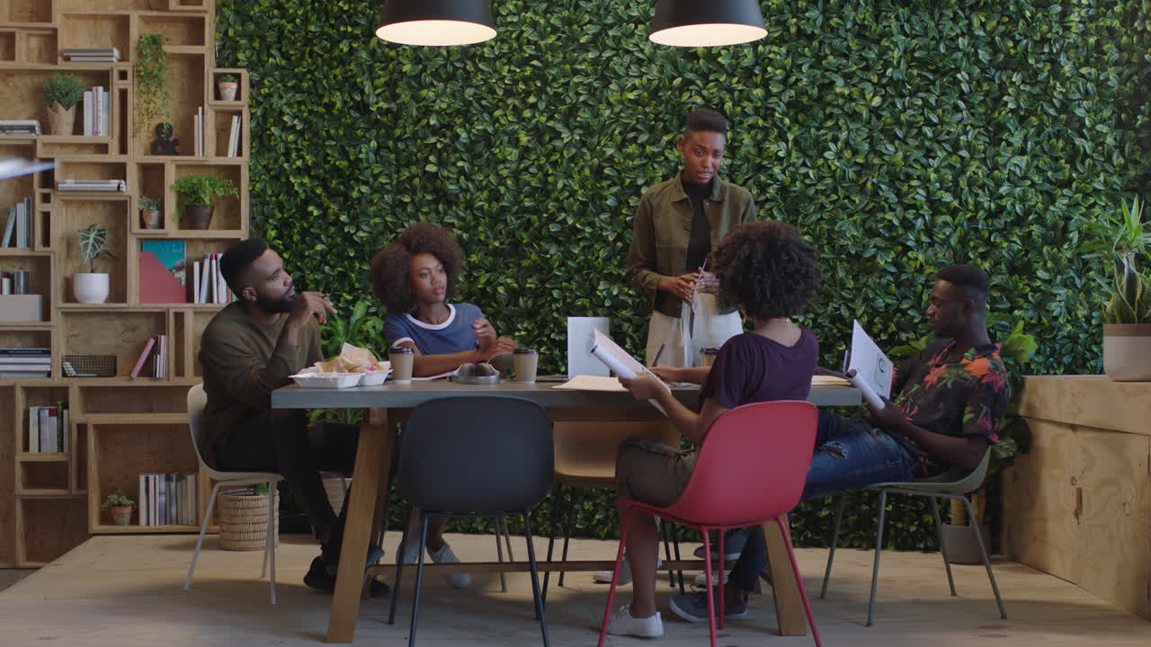 young black business people meeting team leader woman sharing creative ideas colleagues working together brainstorming project in sustainable office