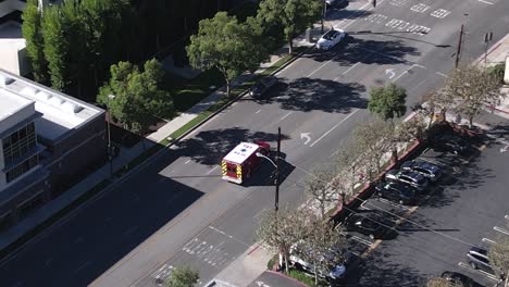 aerial view tracking paramedic truck driving through city streets fast emergency response