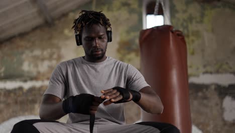 Male-Boxer-Is-Wrapping-Hands-With-Black-Bandage