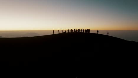 people standing in the summit of acatenango volcano admiring the majestic sunrise in guatemala