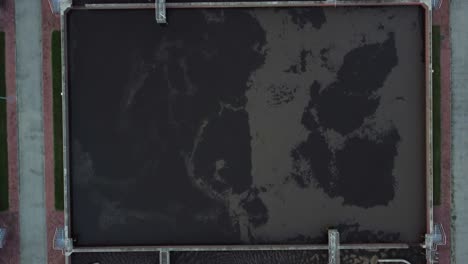 aerial view of wastewater treatment plant at sunset, filtration of dirty or sewage water.