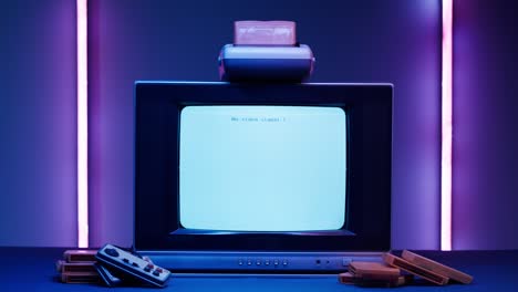 old television with white screen on purple neon background. close-up of vintage tv and cartridges for retro playstation. antique video game, nostalgia