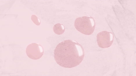 animation of liquid pink blobs moving on pink background