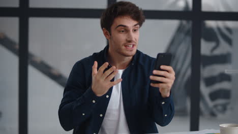 close-up view of cheerful guy having video chat on smartphone