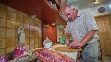 Old-Man-Slice-Salami-Meat-Platter-with-Kitchen-Knife-on-Chopping-Board