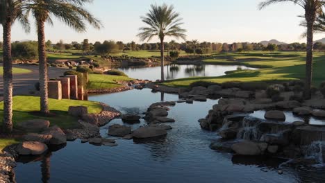 drone footage from a golf course near a residential neighborhood in arizona. shot of the water hazard near the course.