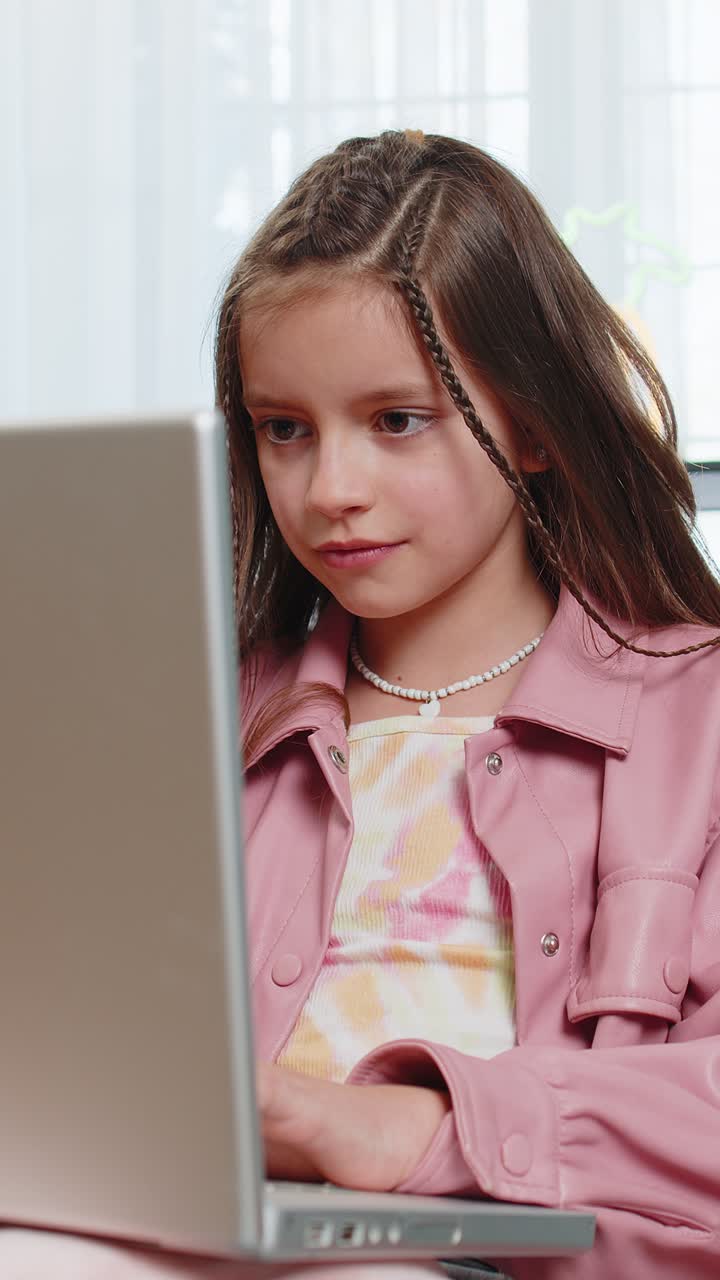 Surprised happy amazed girl child using laptop computer receive good news message celebrate win