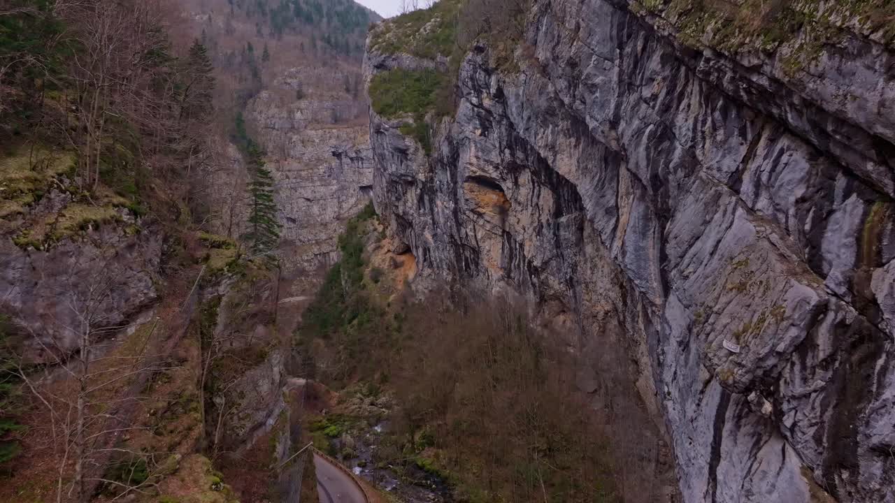 Aerial look at Vercors cliffs and mountain road below