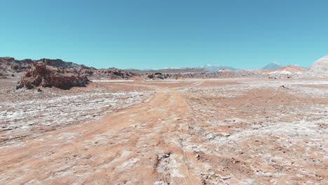 aerial action shot near the ground of salt desert of atacama, chile, south america