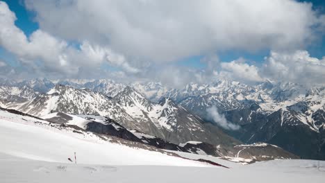 Air-flight-through-mountain-clouds-over-beautiful-snow-capped-peaks-of-mountains-and-glaciers.