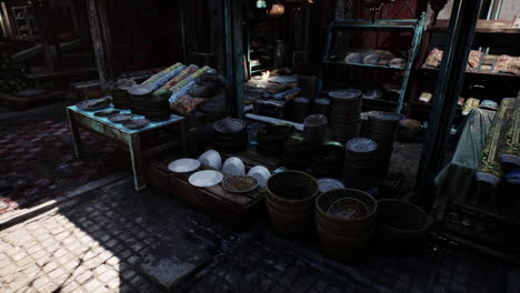 a market stall selling ceramic plates and textiles