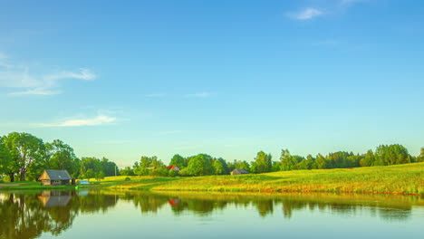 timelapse of a picturesque countryside home with lake and sweeping cirrus clouds