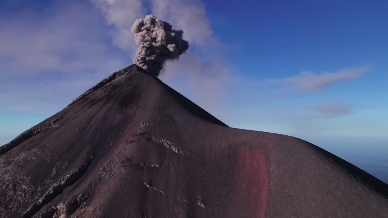 Acatenango, Guatemala - A Dark Volcanic Cone Rises Sharply as a Thick Plume of Ash Billows from its Summit - Tilt Reveal Drone Shot