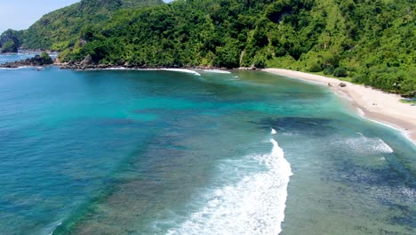 Waves-wash-pristine-tropical-Wediombo-beach,-Wonosari-Indonesia