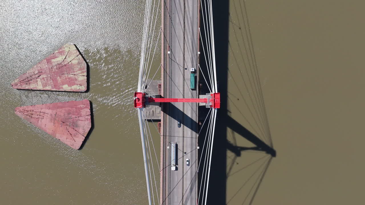 Drone view of Justo Jose de urquiza bridge above the wide Parana Guazu river, a vast waterway, Buenos Aires Argentina. Top down view ascending