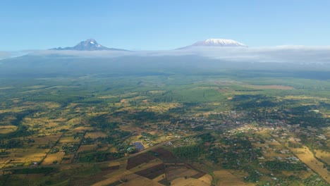 kenya landscape with a village, kilimanjaro and amboseli national park - tracking, drone aerial view