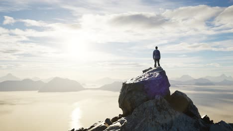 adventurous male hiker standing on dramatic rocky peak